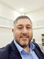 A person in a suit
AI-generated content may be incorrect.